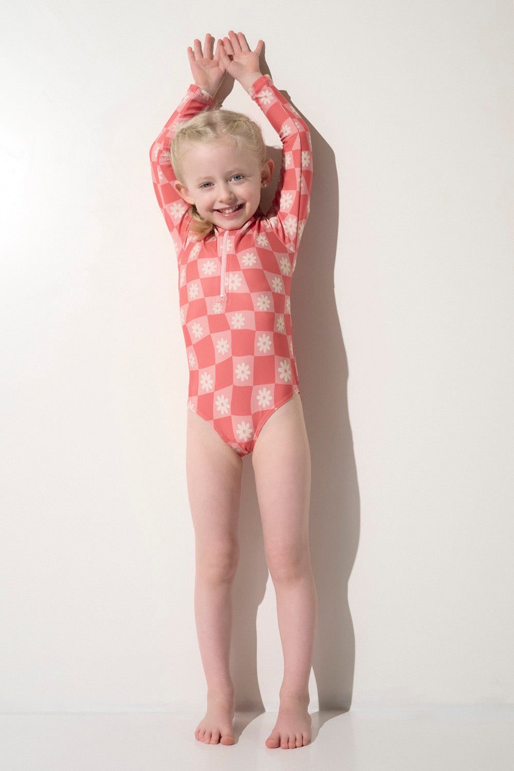 Maillot de bain une pièce anti-UV rose à motifs, idéal pour enfants, avec protection UPF 50+ et confort pour jouer.